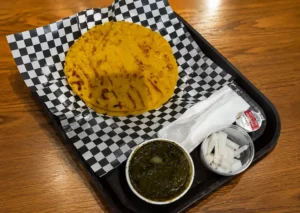 Traditional mustard greens served with corn flatbread and ghee.