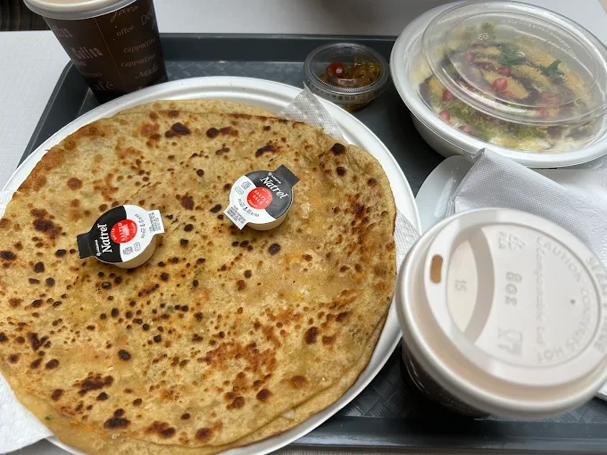 Punjabi Paranthas - Stuffed paranthas served hot with butter and pickles.